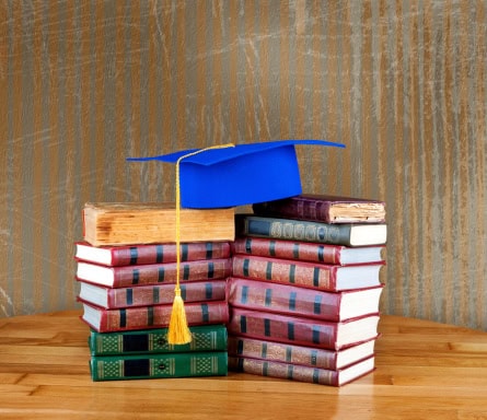 Graduation mortarboard on top of stack of books